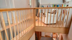 A wooden staircase with a handrail leading to a second-floor landing. - Holiday Home Waldhaus am Burbach (Bad Berleburg)