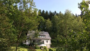 A house surrounded by dense greenery and trees. - Holiday Home Waldhaus am Burbach (Bad Berleburg)