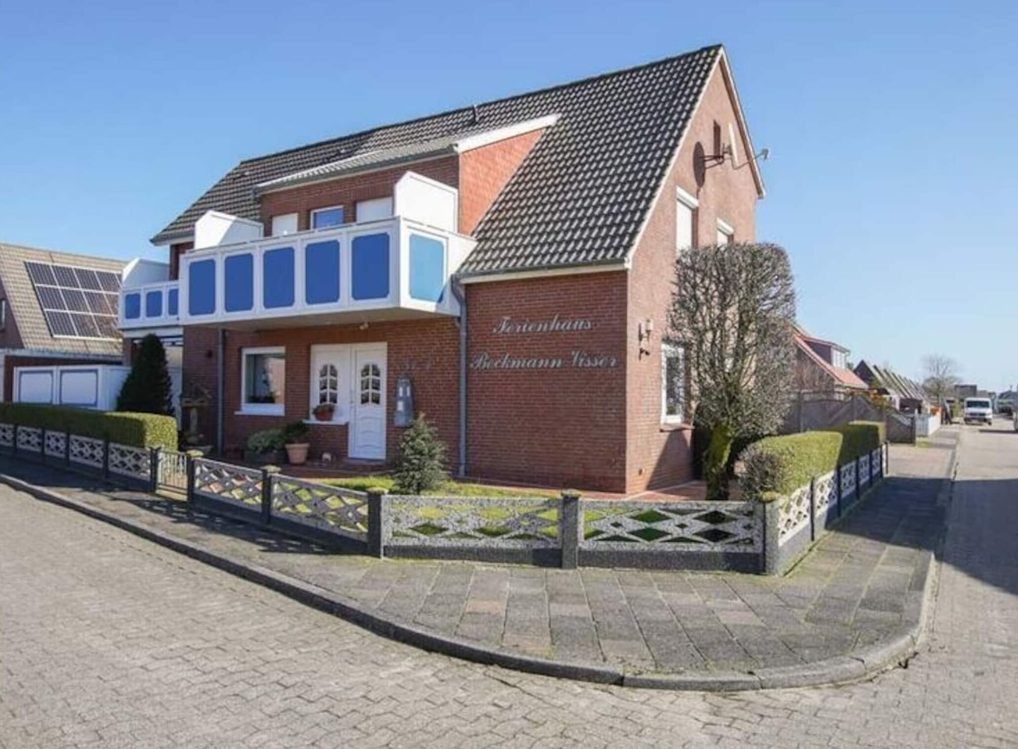 A two-story building with a brick facade and a tiled roof.
