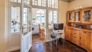 A spacious kitchen with wooden cabinets, a dining area with a table and chairs, and a view of the outside through large windows. - "seashell" Modern Retreat (Binz)