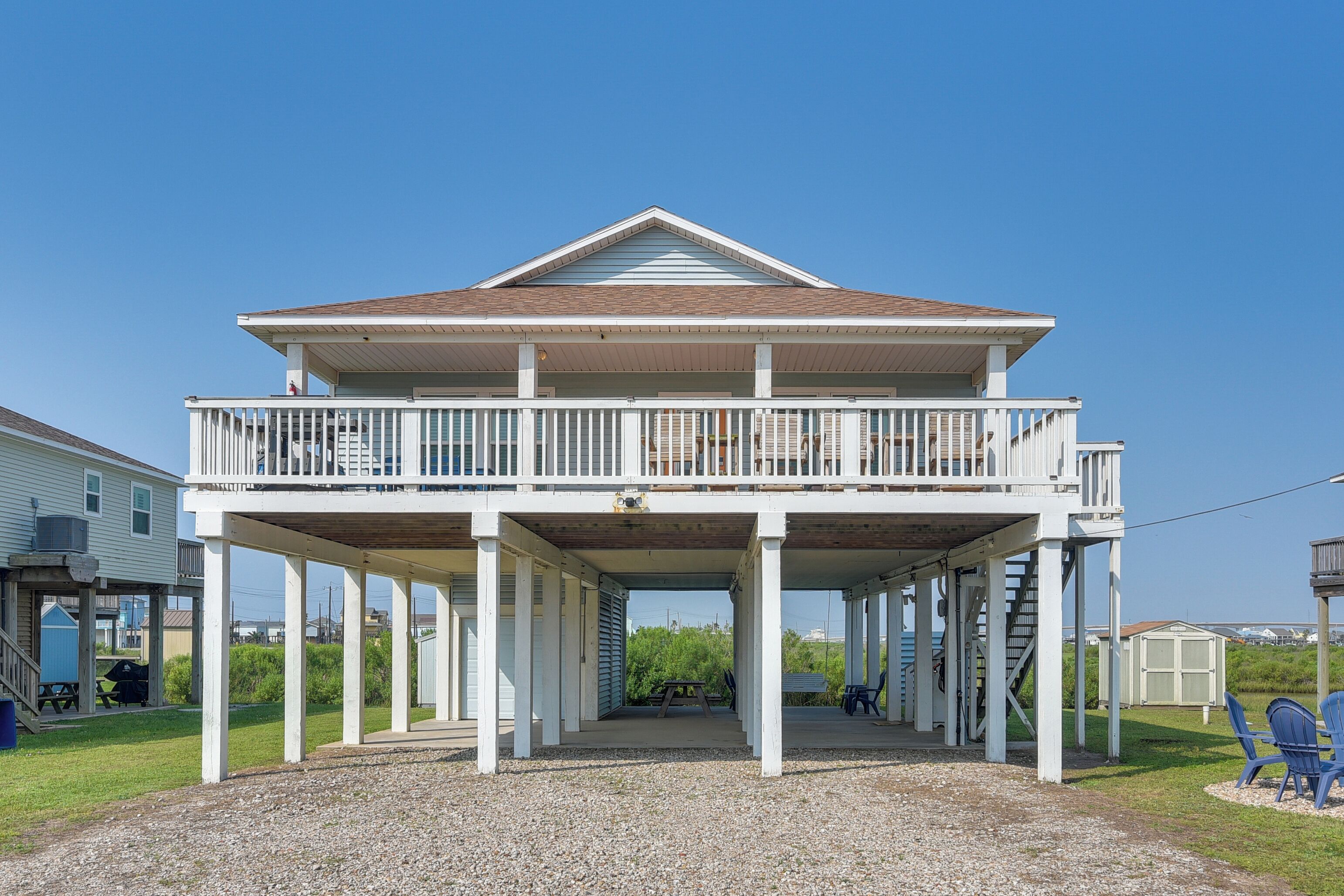 A two-story house with a balcony and a covered porch.