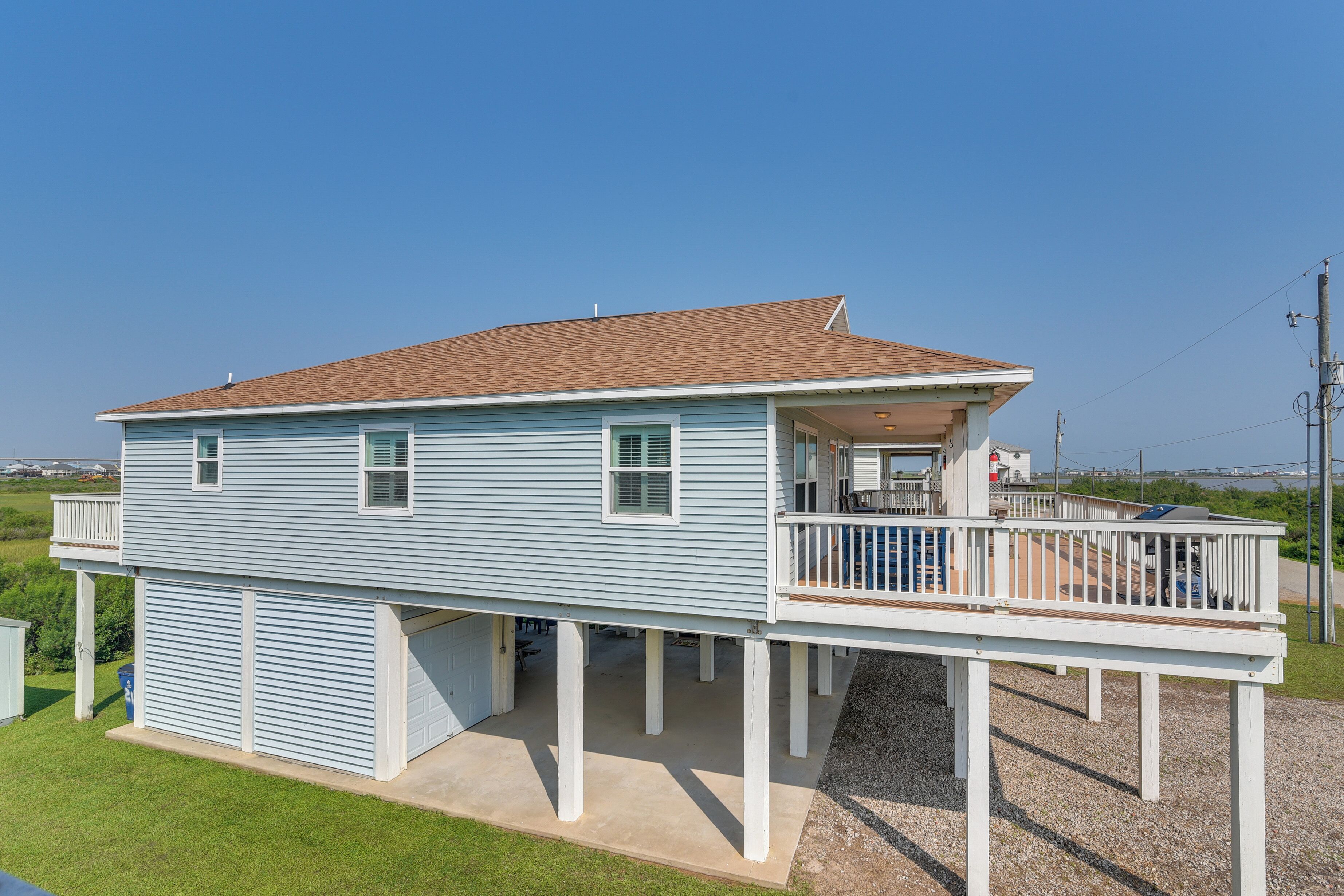 A two-story house with a covered porch and a garage.