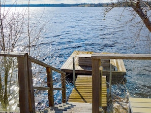 A wooden dock extending into a body of water, with a staircase leading down to the water's edge. - 5 Star Holiday Home in Hjaltevad (Hjältevad)