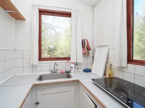 A small kitchen with a window, a sink, and a stove. - 5 Person Holiday Home in Rorvig (Rørvig)