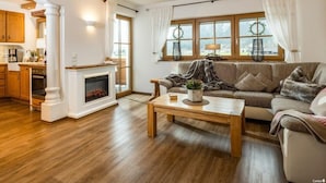 A cozy living room with a fireplace, a sofa, and a coffee table. - Hochkalter - Reich Family (Schoenau am Koenigssee)