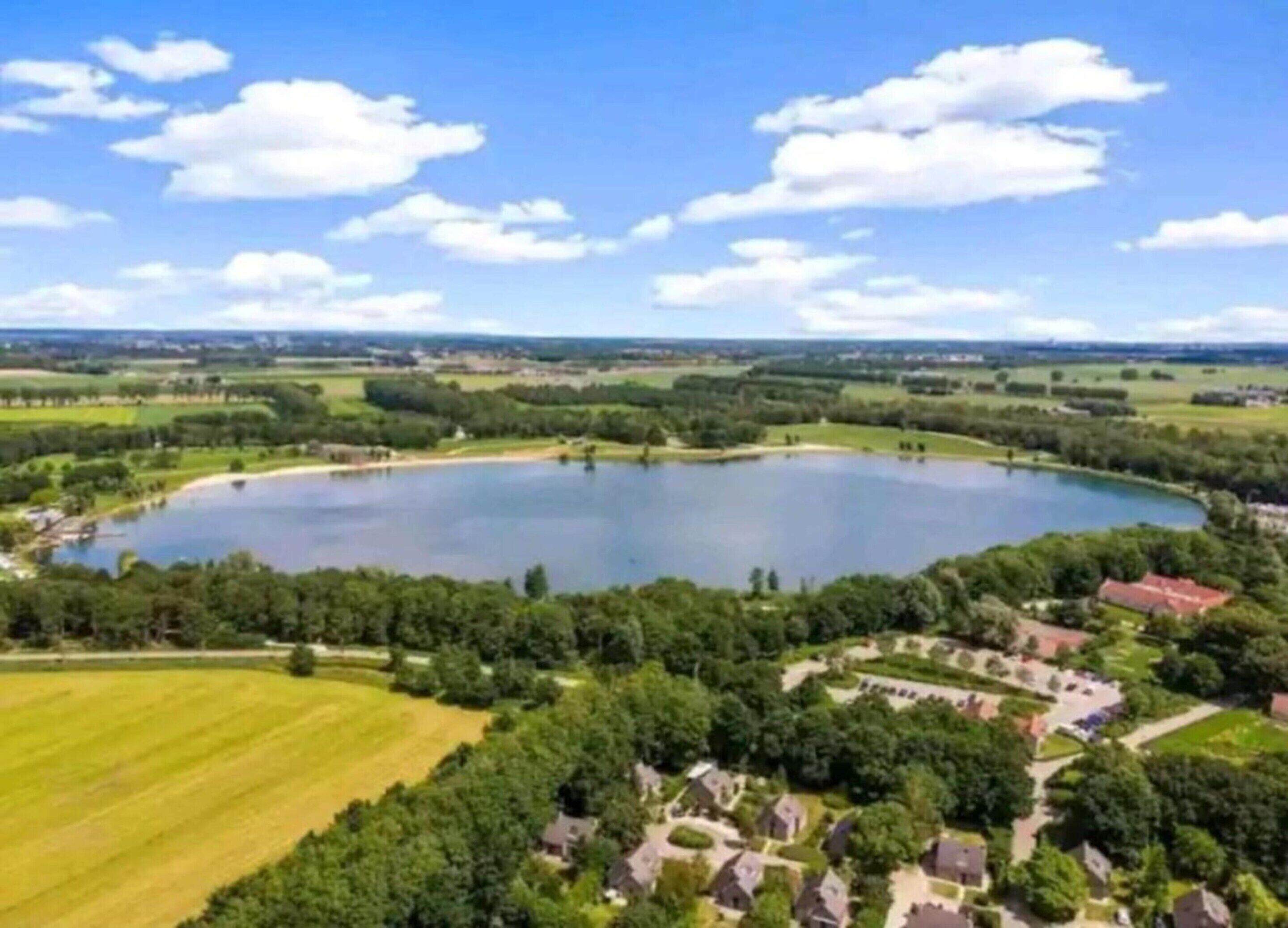A large lake surrounded by greenery and residential areas.