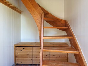 A wooden staircase with a wooden chest of drawers at the bottom. - 4 Person Holiday Home in Hedekas (Hedekas)