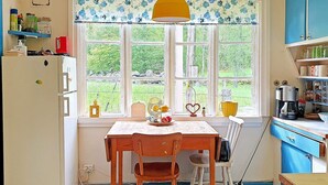 A kitchen with a window, a table with chairs, a refrigerator, and a coffee maker. - 4 Person Holiday Home in Solvesborg-by Traum (Sölvesborg)