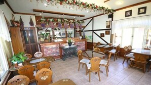A restaurant with wooden furniture, a brick counter, and hanging decorations. - Xiangqing Garden Leisure Cabin (Nantou)