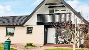 A modern two-story house with a sloped roof, a balcony, and a small front garden. - 4 Star Holiday Home in Halmstad (Halmstad)