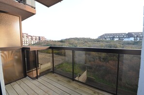 Enjoy a peaceful view of the surrounding residential area from this balcony with a clear view.