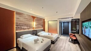A modern hotel room with two beds, a large wall-mounted TV, and a wooden floor. - Conch International Hotel (Yingde)