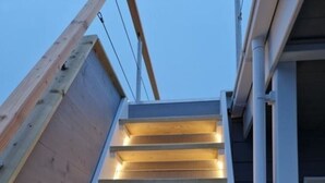 A modern building with a sloped roof and wooden beams. - Houseboat Liliput Comfortable Holiday Residence (Stralsund)