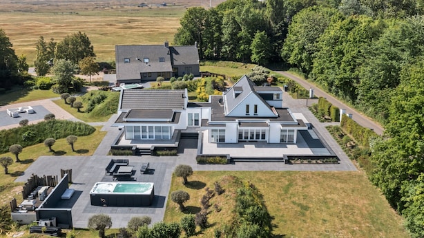 A modern two-story house with a large patio area, a swimming pool, and a well-maintained garden. - Wellness Villa With Sauna, spa Near Beach (Ouddorp)
