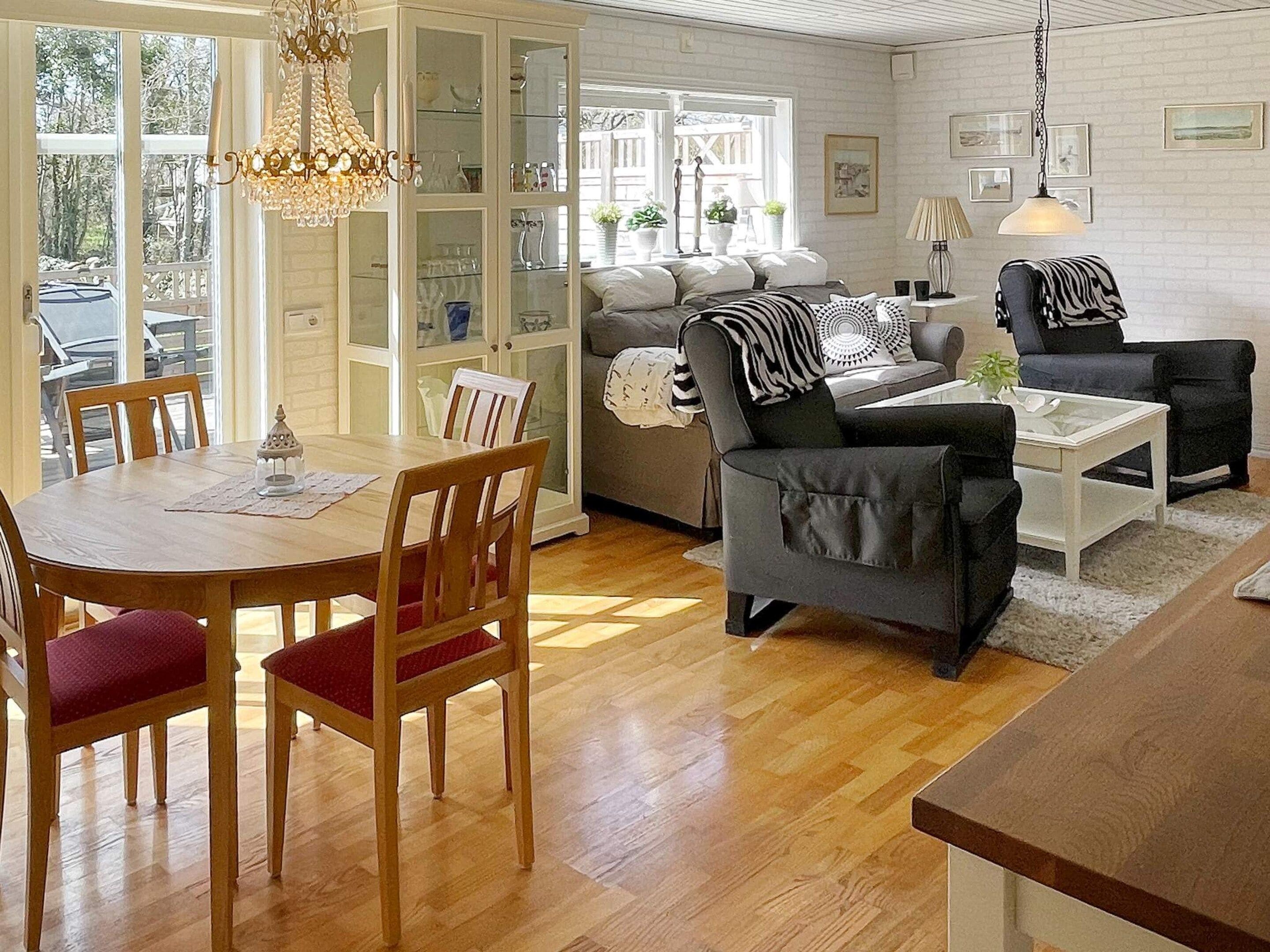 A spacious living area with a dining table, chairs, a sofa, and a coffee table.