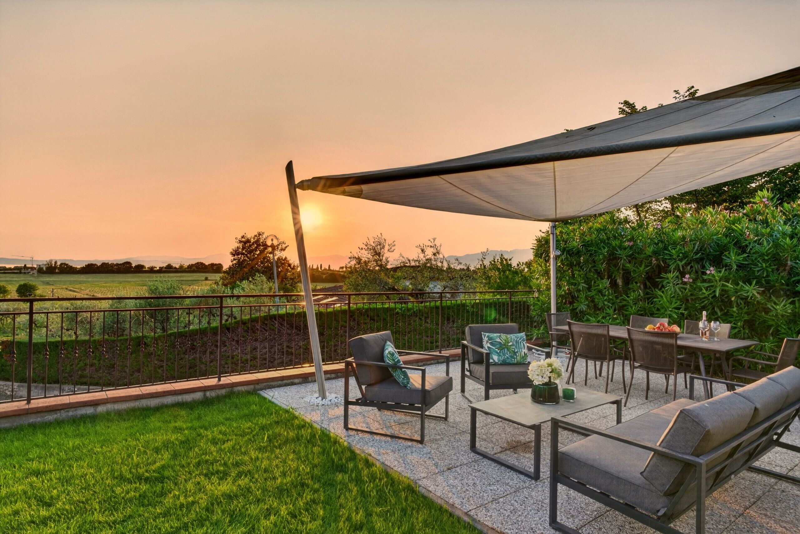An outdoor patio with a table, chairs, and a canopy.