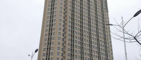 A tall building with multiple windows and a uniform facade.