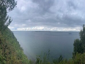 A calm body of water with a distant shoreline, surrounded by dense greenery. - 8 Person Holiday Park Home in Bogense (Bogense)