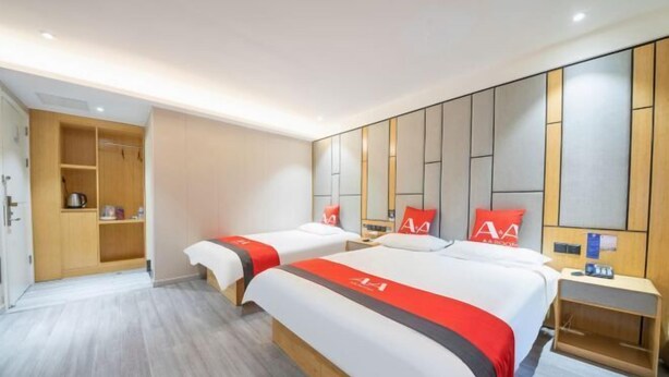 A hotel room with two beds, a wardrobe, a bedside table, and a mirror on the wall. - AA Hotel Chain (Quzhou International Financial Center Shuiting Branch) (Quzhou)