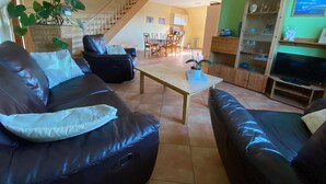 A living room with a sofa, a coffee table, and a TV stand. - Inviting Apartment in Pruchten With Garden (Pruchten)