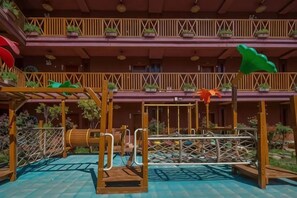 A multi-level outdoor play area with wooden structures and potted plants. - YingHuoChong (Ninglang)