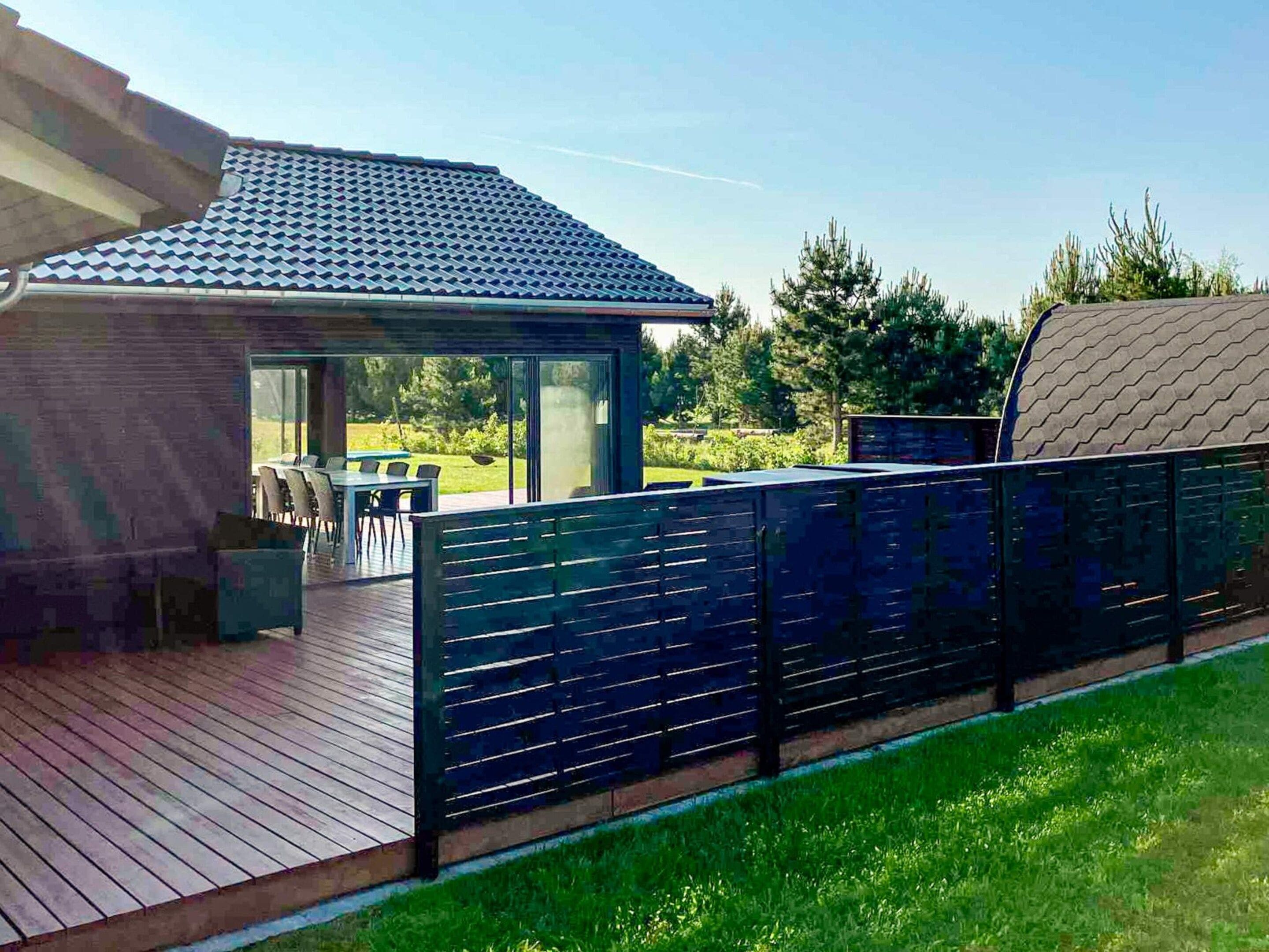 A residential property with a covered patio, a dining area, and a view of the surrounding landscape.