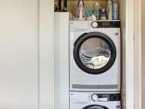 A front-loading washing machine with a control panel and a lower dryer. - 5 Star Holiday Home in Vaeggerlose (Vaeggerlose)