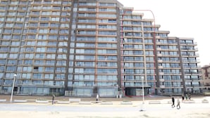 A multi-story residential building with balconies, a central courtyard, and a pedestrian walkway. - Apartment in Nieuwpoort With Sea Views (Nieuwpoort)