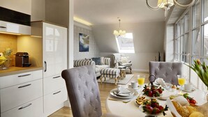 A modern dining area with a round table set for breakfast, featuring a fruit platter, bread, and beverages. - Holiday Home by the Baltic Sea (Zingst)