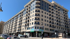 A multi-story hotel with balconies, a ground floor entrance, and a visible restaurant. - Belvilla by OYO Apartment in Fuengirola (Fuengirola)