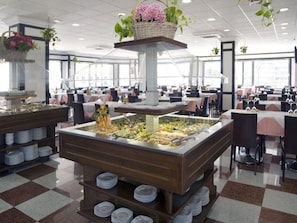 Enjoy a diverse spread at our central buffet, featuring multiple serving stations and a variety of dishes.