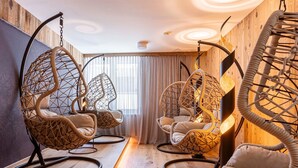 A room with three hanging chairs, wooden flooring, and a large window with curtains. - Modern Holiday Apartment With Balcony (Fuegen)