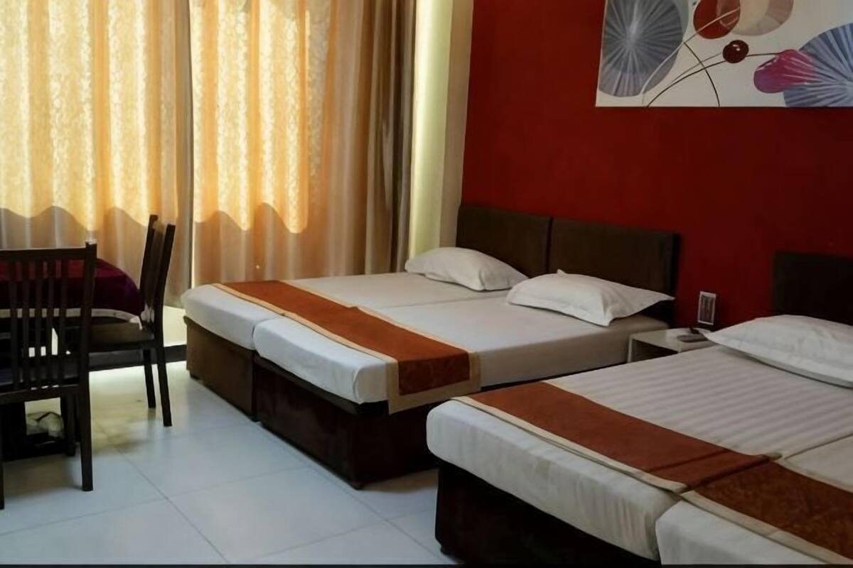 Una habitación de hotel con dos camas, un escritorio y una silla.