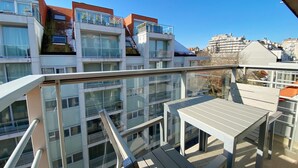 A modern apartment building with multiple balconies, large windows, and a view of other buildings. - Apartment in Nieuwpoort by the Beach (Nieuwpoort)