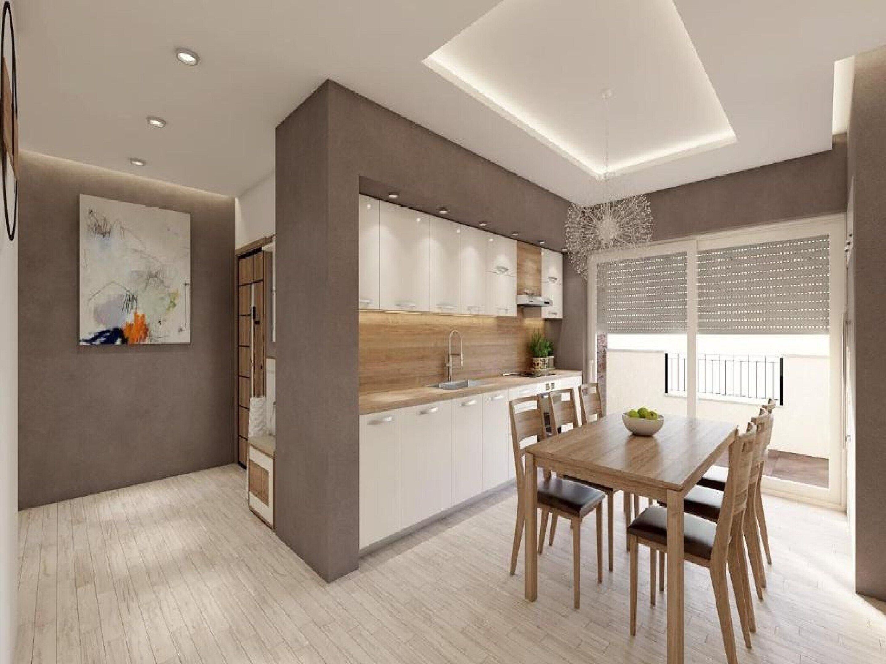 Una cocina moderna con armarios blancos, encimera de madera y un comedor con mesa y sillas.