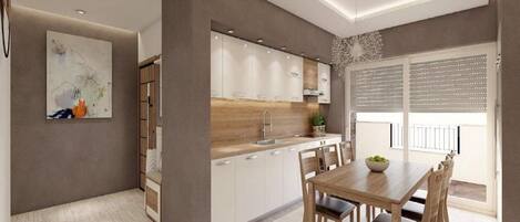 Una cocina moderna con armarios blancos, encimera de madera y un comedor con mesa y sillas.