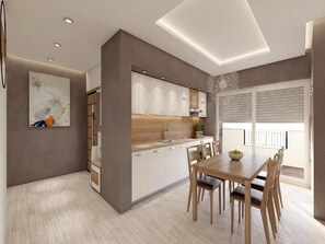 A modern kitchen with white cabinets, a wooden countertop, and a dining area with a table and chairs.
