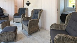 A room with wicker furniture, including chairs and a sofa, against a light-colored wall. - 12 Person Holiday Home in Hadsund-by Traum (Hadsund)