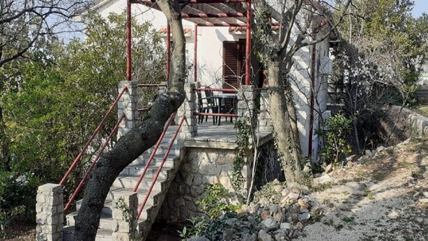 A stone staircase leading to a wooden pergola with a table and chairs underneath. - Apartments Rudi - One Bedroom Apartment With Terrace (Novi Vinodolski)