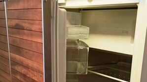 A refrigerator with multiple transparent storage drawers and a metal handle. - With Lake and Alpine View (Immenstaad am Bodensee)