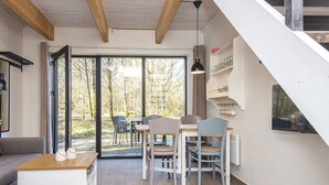 A modern interior with a dining area, a sofa, and a staircase. - 5 Star Holiday Home in Hovborg (Hovborg)