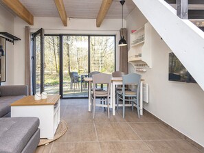 A modern interior with a dining area, a sofa, and a staircase. - 5 Star Holiday Home in Hovborg (Hovborg)