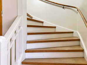 A staircase with white walls and wooden steps. - 4 Person Holiday Home in Hoje (Höje)
