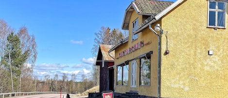 A yellow building with a sign reading 'GUSTAFSONS' and a red signboard with 'ÖPPET' on it.