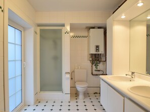 A bathroom with a toilet, sink, and shower. - Beautifully Renovated House Centrally Located (De Haan)