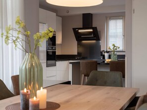 Enjoy cooking in the well-equipped kitchen with a central island, oven, and range hood.