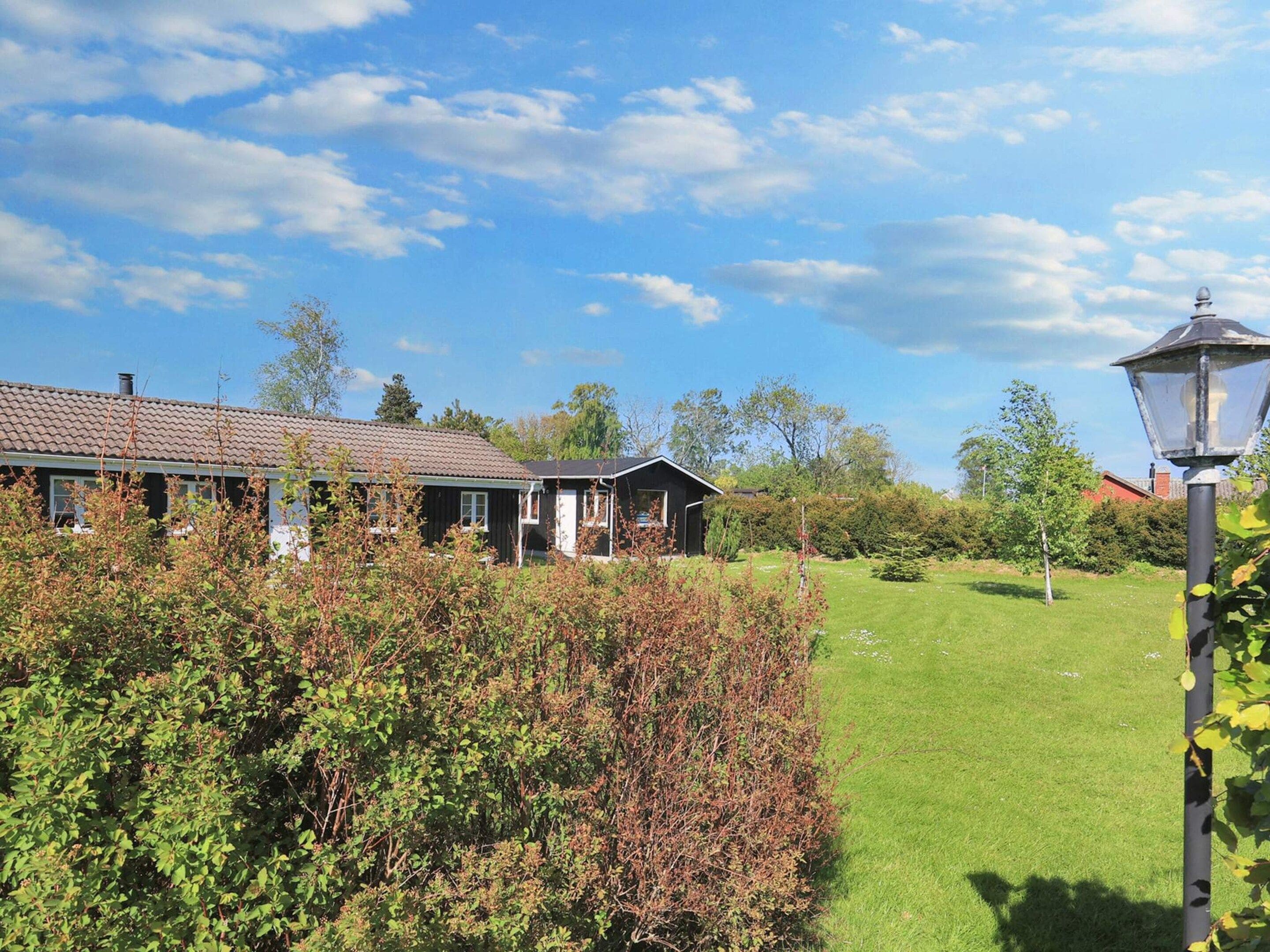 A residential property with a house, a lawn, and a lamp post.