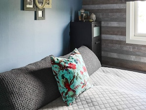 A room with a sofa, a cabinet, and a window.