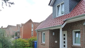A residential building with a brick facade, a red-tiled roof, and a small porch area. - Holiday Home Manders (Wangerland)