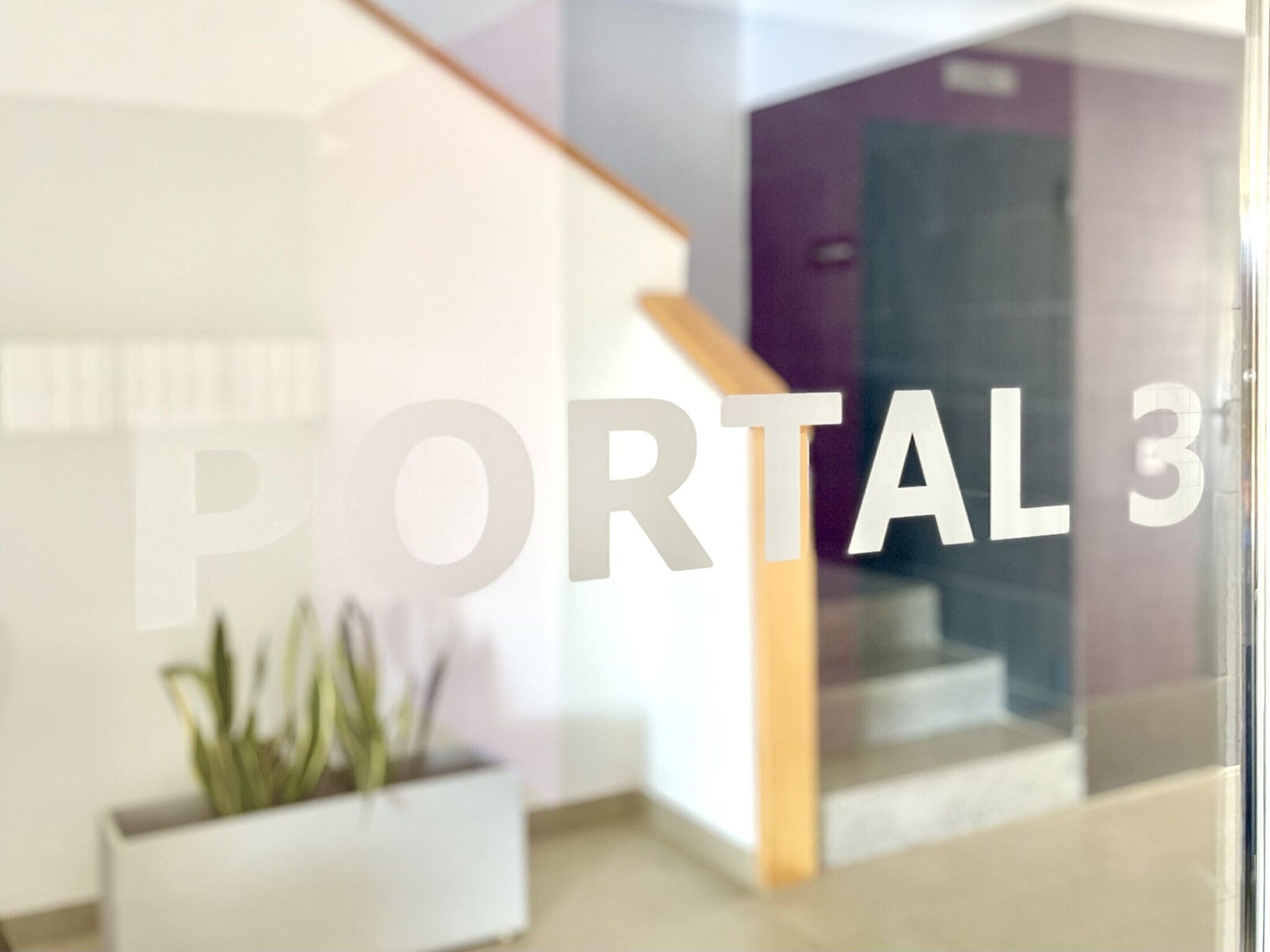 A modern interior with a glass door displaying 'PORTAL 3'.